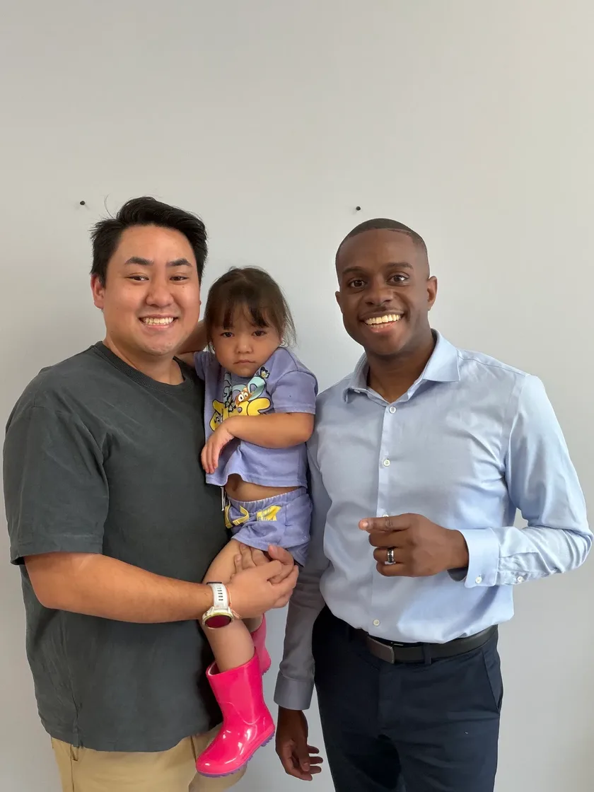 A father and daughter with Dr. Matthew Richmond after family chiropractic care in Suwanee, GA